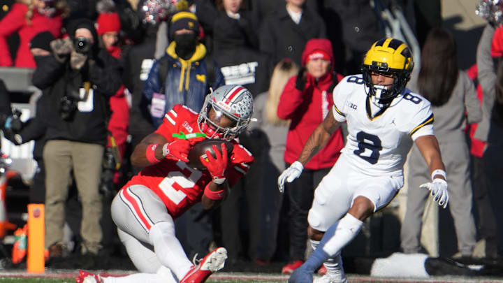 Ohio State football safety Caleb Downs makes an interception during the third period during the NCAA football game against the Michigan Wolverines Saturday, November 30, 2024 in Ohio Stadium.