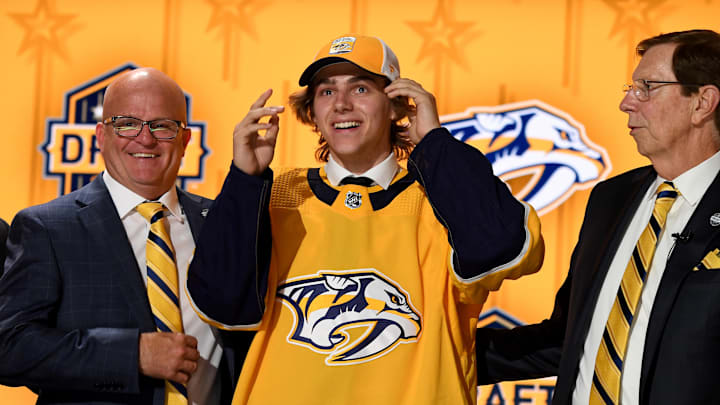 Jun 28, 2023; Nashville, Tennessee, USA; Nashville Predators draft pick Tanner Molendyk puts on a hat after being selected with the twenty fourth pick in round one of the 2023 NHL Draft at Bridgestone Arena. Mandatory Credit: Christopher Hanewinckel-Imagn Images