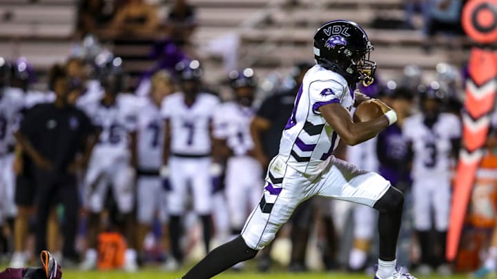 Vista del Lago's Josiah Dupree Boyd outruns a dive by La Quinta's Sebastian Osorio on a quarterback keeper during the fourth quarter of their game in La Quinta, Calif., Friday, Sept. 27, 2024.