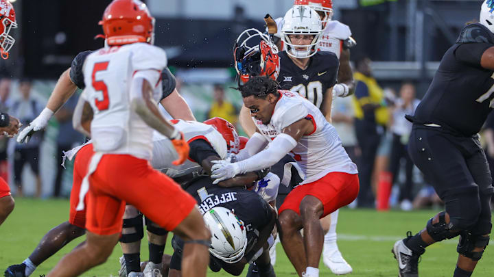Sep 7, 2024; Orlando, Florida, USA; Sam Houston State Bearkats defensive back Caleb Weaver (3) loses his helmet while tackling UCF Knights quarterback KJ Jefferson (1) during the first quarter against the at FBC Mortgage Stadium. Mandatory Credit: Mike Watters-Imagn Images