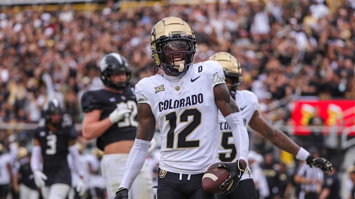 Sep 28, 2024; Orlando, Florida, USA; Colorado Buffaloes wide receiver Travis Hunter (12) scores a touchdown against the UCF Knights during the first quarter at FBC Mortgage Stadium. Mandatory Credit: Mike Watters-Imagn Images