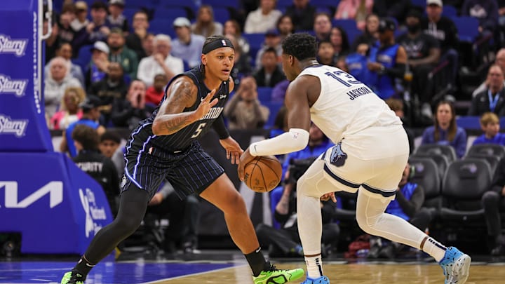 Feb 21, 2025; Orlando, Florida, USA; Orlando Magic forward Paolo Banchero (5) defends Memphis Grizzlies forward Jaren Jackson Jr. (13) during the first quarter at Kia Center. Mandatory Credit: Mike Watters-Imagn Images