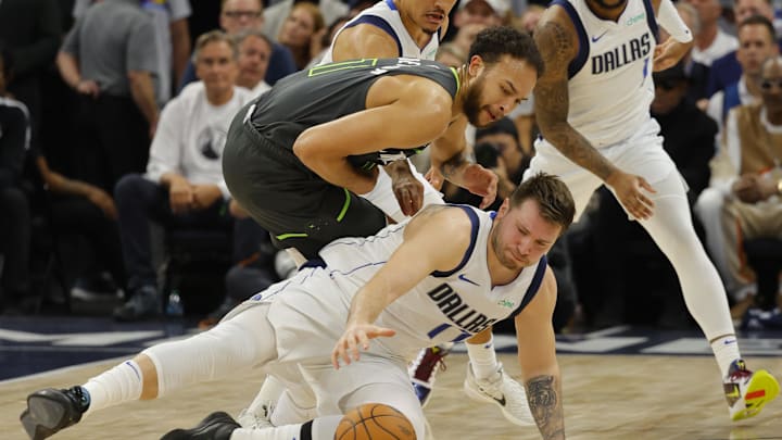 May 30, 2024; Minneapolis, Minnesota, USA; Dallas Mavericks guard Luka Doncic (77) and Minnesota Timberwolves forward Kyle Anderson (1) fight for a loose ball during the second quarter in game five of the western conference finals for the 2024 NBA playoffs at Target Center. Mandatory Credit: Bruce Kluckhohn-USA TODAY Sports
