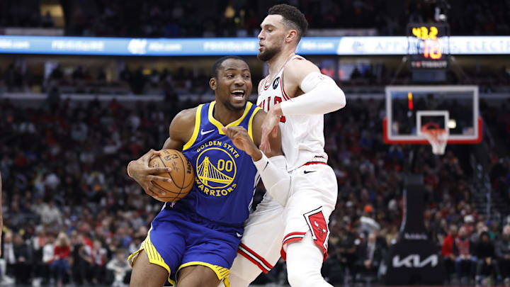 Jan 12, 2024; Chicago, Illinois, USA; Golden State Warriors forward Jonathan Kuminga (00) drives against Chicago Bulls guard Zach LaVine (8)