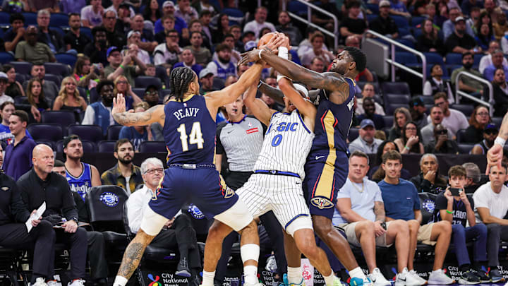 Oct 16, 2025; Orlando, Florida, USA; Orlando Magic guard Anthony Black (0) is defended by New Orleans Pelicans guard/forward Micah Peavy (14) and forward Zion Williamson (1) during the second quarter at Kia Center. Mandatory Credit: Mike Watters-Imagn Images Oct 16, 2025; Orlando, Florida, USA; Orlando Magic guard Anthony Black (0) is defended by New Orleans Pelicans guard/forward Micah Peavy (14) and forward Zion Williamson (1) during the second quarter at Kia Center. Mandatory Credit: Mike Watters-Imagn Images