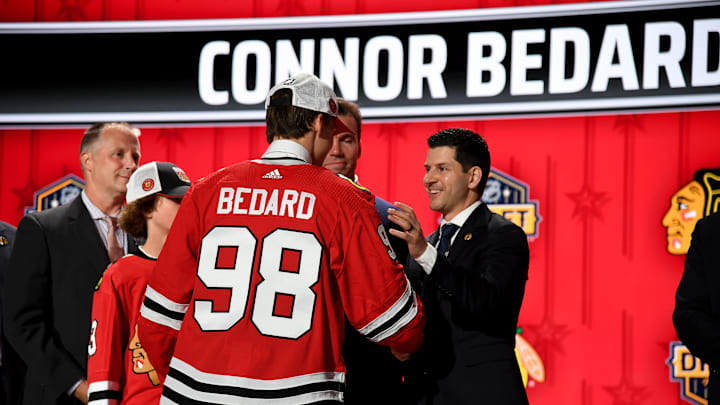 Jun 28, 2023; Nashville, Tennessee, USA; Chicago Blackhawks general manager Kyle Davidson congratulates first overall pick Connor Bedard during the 2023 NHL Draft at Bridgestone Arena. Mandatory Credit: Christopher Hanewinckel-Imagn Images