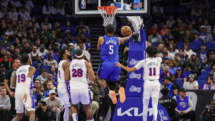 Jan 12, 2025; Orlando, Florida, USA; Orlando Magic forward Paolo Banchero (5) goes to the basket against the Philadelphia 76ers during the second quarter at Kia Center. Mandatory Credit: Mike Watters-Imagn Images