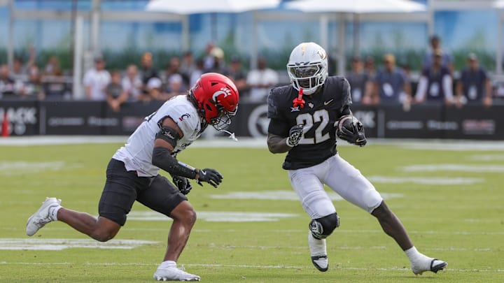 Oct 12, 2024; Orlando, Florida, USA; Cincinnati Bearcats defensive back Derrick Canteen (10) moves in for the tackle against UCF Knights running back Myles Montgomery (22) during the first quarter at FBC Mortgage Stadium. Mandatory Credit: Mike Watters-Imagn Images Oct 12, 2024; Orlando, Florida, USA; Cincinnati Bearcats defensive back Derrick Canteen (10) moves in for the tackle against UCF Knights running back Myles Montgomery (22) during the first quarter at FBC Mortgage Stadium. Mandatory Credit: Mike Watters-Imagn Images