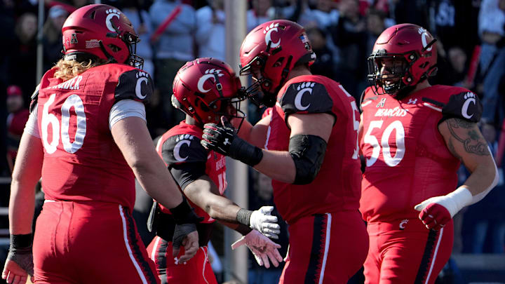 Nov. 25, 2022; Cincinnati, Ohio, USA; Cincinnati Bearcats running back Charles McClelland (10) celebrates a touchdown run with the offensive line in the second quarter against the Tulane Green Wave at Nippert Stadium. Mandatory Credit: Kareem Elgazzar/The Enquirer / USA TODAY NETWORK