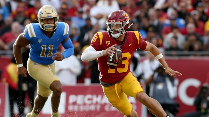 Nov 18, 2023; Los Angeles, California, USA; USC Trojans quarterback Caleb Williams (13) scrambles during the third quarter against the UCLA Bruins at United Airlines Field at Los Angeles Memorial Coliseum. Mandatory Credit: Jason Parkhurst-Imagn Images
