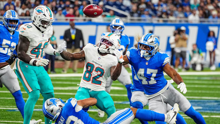Miami Dolphins wide receiver Dee Eskridge (82) fumbles the ball after being tackled by Detroit Lions running back Sione Vaki during the first quarter of the preseason game at Ford Field in Detroit, Saturday, Aug. 16, 2025.