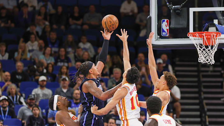 Apr 8, 2025; Orlando, Florida, USA; Orlando Magic forward Paolo Banchero (5) shoots against Atlanta Hawks forward Zaccharie Risacher (10) during the first quarter at Kia Center. Mandatory Credit: Mike Watters-Imagn Images