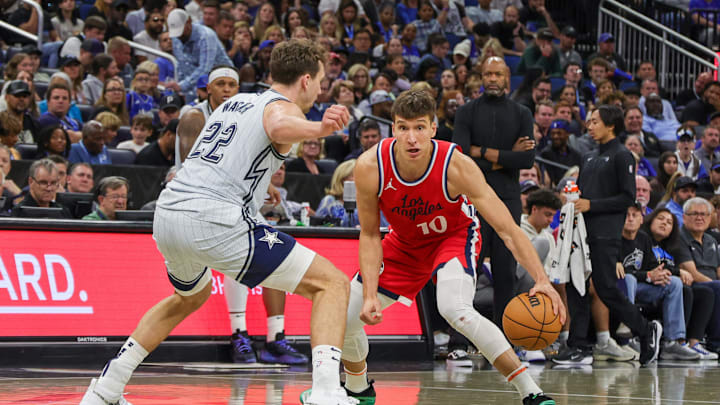 Mar 31, 2025; Orlando, Florida, USA; LA Clippers guard Bogdan Bogdanovic (10) dribbles against Orlando Magic forward Franz Wagner (22) during the second half at Kia Center. Mandatory Credit: Mike Watters-Imagn Images