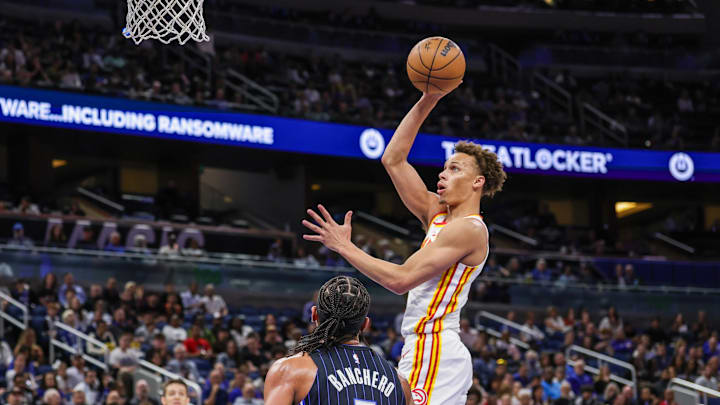 Apr 8, 2025; Orlando, Florida, USA; Atlanta Hawks guard Dyson Daniels (5) goes to the basket in front of Orlando Magic forward Paolo Banchero (5) during the first quarter at Kia Center. Mandatory Credit: Mike Watters-Imagn Images