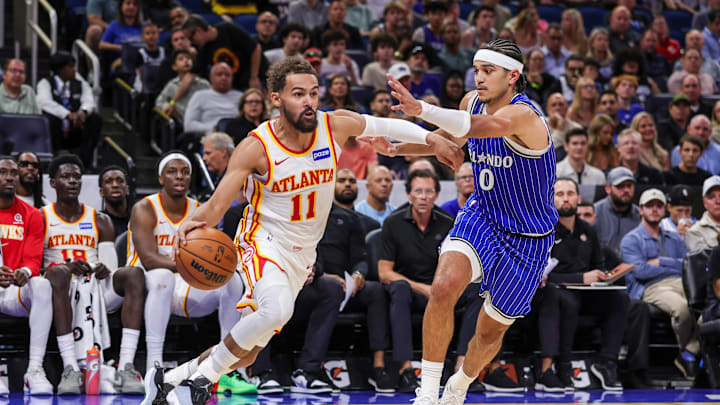 Oct 24, 2025; Orlando, Florida, USA; Atlanta Hawks guard Trae Young (11) drives around Orlando Magic guard Anthony Black (0) during the second quarter at Kia Center. Mandatory Credit: Mike Watters-Imagn Images Oct 24, 2025; Orlando, Florida, USA; Atlanta Hawks guard Trae Young (11) drives around Orlando Magic guard Anthony Black (0) during the second quarter at Kia Center. Mandatory Credit: Mike Watters-Imagn Images