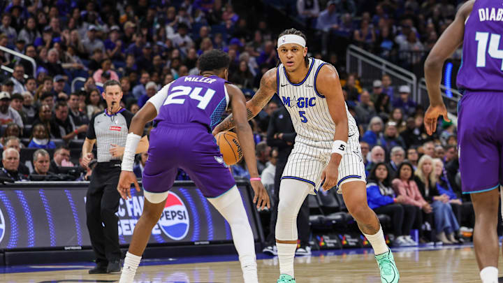Dec 26, 2025; Orlando, Florida, USA; Orlando Magic forward Paolo Banchero (5) handles the ball in front of Charlotte Hornets forward Brandon Miller (24) during the first quarter at Kia Center. Mandatory Credit: Mike Watters-Imagn Images