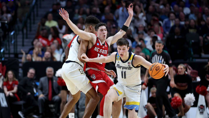 Mar 29, 2024; Dallas, TX, USA; Marquette Golden Eagles guard Tyler Kolek (11) dribbles as forward Oso Ighodaro (13) picks North Carolina State Wolfpack guard Michael O'Connell (12) during the first half in the semifinals of the South Regional of the 2024 NCAA Tournament at American Airlines Center. Mandatory Credit: Tim Heitman-USA TODAY Sports 