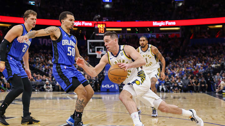 Mar 10, 2024; Orlando, Florida, USA; Indiana Pacers guard T.J. McConnell (9) drives past Orlando Magic guard Cole Anthony (50) during the second half at KIA Center. Mandatory Credit: Mike Watters-Imagn Images