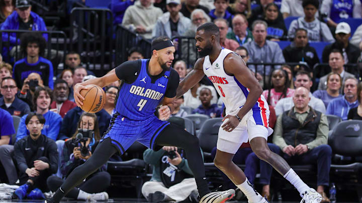 Jan 25, 2025; Orlando, Florida, USA; Orlando Magic guard Jalen Suggs (4) drives to the basket against Detroit Pistons forward Tim Hardaway Jr. (8) during the first quarter at Kia Center. Mandatory Credit: Mike Watters-Imagn Images