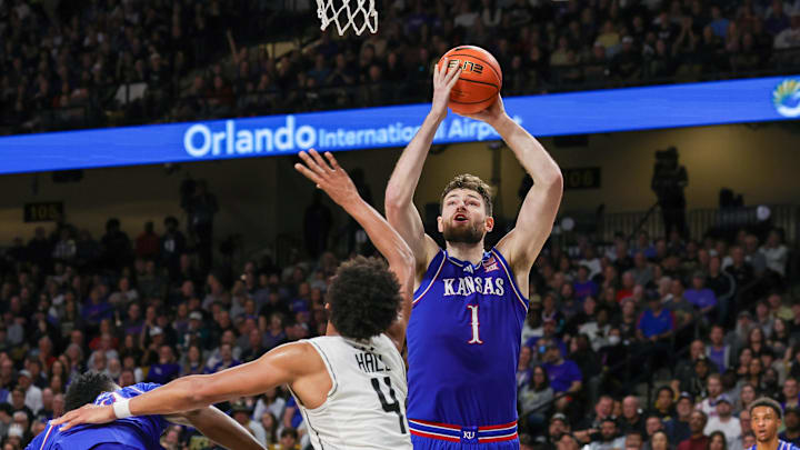 Jan 5, 2025; Orlando, Florida, USA; Kansas Jayhawks center Hunter Dickinson (1) shoots the ball against UCF Knights guard Keyshawn Hall (4) during the second half at Addition Financial Arena. Mandatory Credit: Mike Watters-Imagn Images