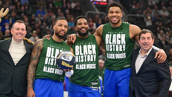 Feb 12, 2024; Milwaukee, Wisconsin, USA;  NBA All-Star participants Milwaukee Bucks guard Damian Lillard (0), guard Malik Beasley (5), and forward Giannis Antetokounmpo (34) pose for a picture with general manager Jon Horst (far left) and team president Peter Feigin (far right) before a game against the Denver Nuggets at Fiserv Forum. Mandatory Credit: Benny Sieu-Imagn Images
