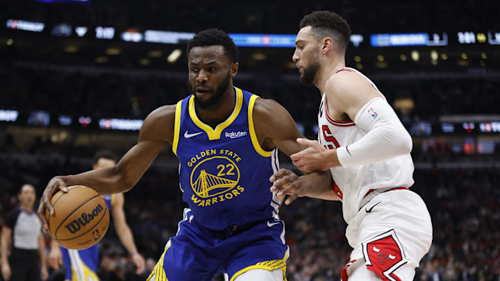 Jan 12, 2024; Chicago, Illinois, USA; Golden State Warriors forward Andrew Wiggins (22) dribbles against Chicago Bulls guard Zach LaVine (8) during the first half at United Center. Mandatory Credit: Kamil Krzaczynski-Imagn Images