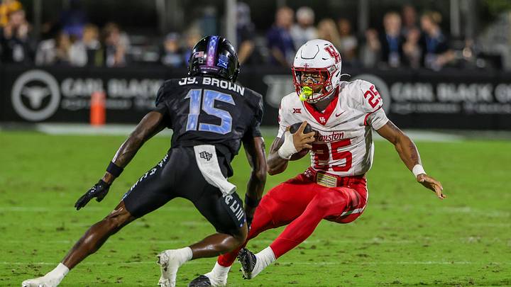 Nov 7, 2025; Orlando, Florida, USA; Houston Cougars running back DJ Butler (25) runs the ball against UCF Knights cornerback Jyaire Brown (15) during the first quarter at Acrisure Bounce House. Mandatory Credit: Mike Watters-Imagn Images Nov 7, 2025; Orlando, Florida, USA; Houston Cougars running back DJ Butler (25) runs the ball against UCF Knights cornerback Jyaire Brown (15) during the first quarter at Acrisure Bounce House. Mandatory Credit: Mike Watters-Imagn Images