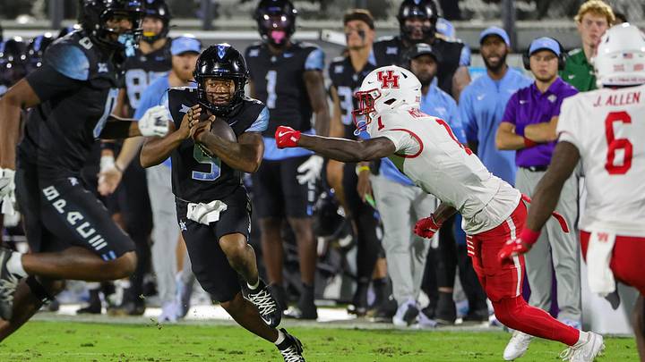 Nov 7, 2025; Orlando, Florida, USA; UCF Knights running back Jaden Nixon (5) carries the ball against Houston Cougars defensive back Latrell McCutchin Sr. (1) during the first quarter at Acrisure Bounce House. Mandatory Credit: Mike Watters-Imagn Images Nov 7, 2025; Orlando, Florida, USA; UCF Knights running back Jaden Nixon (5) carries the ball against Houston Cougars defensive back Latrell McCutchin Sr. (1) during the first quarter at Acrisure Bounce House. Mandatory Credit: Mike Watters-Imagn Images
