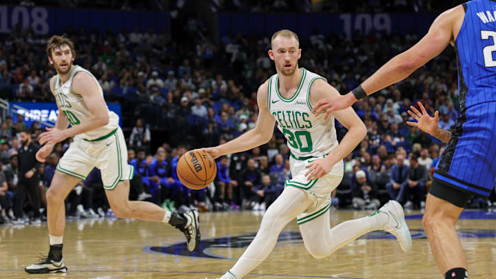 Apr 9, 2025; Orlando, Florida, USA; Boston Celtics forward Sam Hauser (30) brings the ball up court during the second quarter against the Orlando Magic at Kia Center. Mandatory Credit: Mike Watters-Imagn Images
