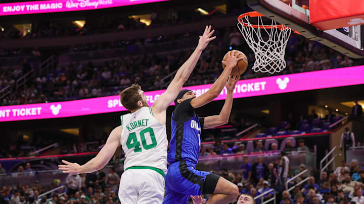Apr 25, 2025; Orlando, Florida, USA; Orlando Magic guard Anthony Black (0) goes to the basket against Boston Celtics center Luke Kornet (40) during the second quarter of game three of first round for the 2024 NBA Playoffs at Kia Center. Mandatory Credit: Mike Watters-Imagn Images