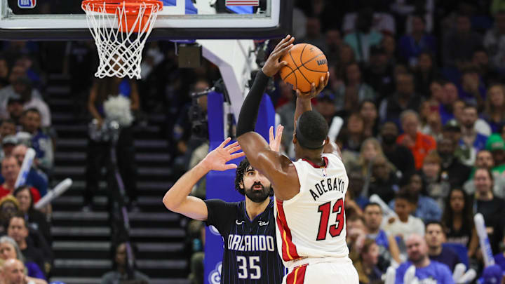 Dec 26, 2024; Orlando, Florida, USA; Miami Heat center Bam Adebayo (13) shoots against Orlando Magic center Goga Bitadze (35) during the second half at Kia Center. Mandatory Credit: Mike Watters-Imagn Images
