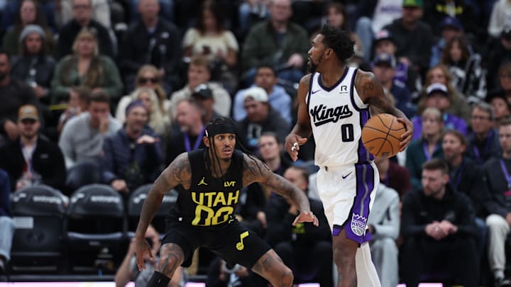 Oct 29, 2024; Salt Lake City, Utah, USA; Sacramento Kings guard Malik Monk (0) looks for a play against Utah Jazz guard Jordan Clarkson (00) during the fourth quarter at Delta Center. Mandatory Credit: Rob Gray-Imagn Images