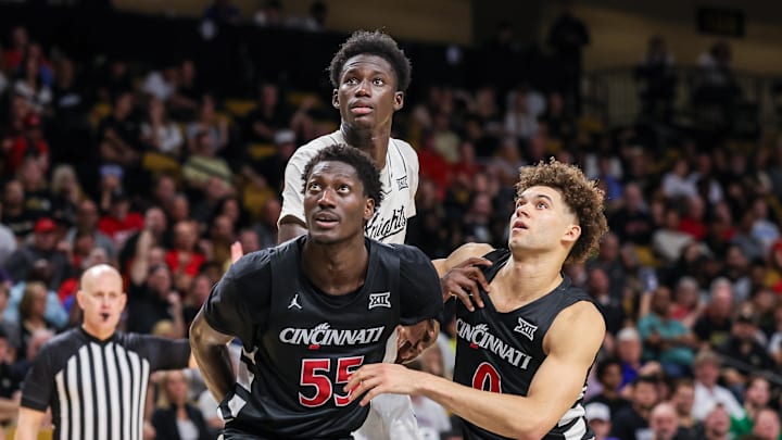 Feb 5, 2025; Orlando, Florida, USA; Cincinnati Bearcats forward Aziz Bandaogo (55), guard Dan Skillings Jr. (0) and UCF Knights center Moustapha Thiam (52) during the second half at Addition Financial Arena. Mandatory Credit: Mike Watters-Imagn Images Feb 5, 2025; Orlando, Florida, USA; Cincinnati Bearcats forward Aziz Bandaogo (55), guard Dan Skillings Jr. (0) and UCF Knights center Moustapha Thiam (52) during the second half at Addition Financial Arena. Mandatory Credit: Mike Watters-Imagn Images