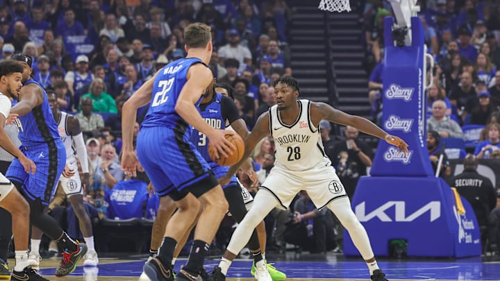 Oct 25, 2024; Orlando, Florida, USA; Brooklyn Nets forward Dorian Finney-Smith (28) defends Orlando Magic forward Franz Wagner (22) during the first quarter at Kia Center. Mandatory Credit: Mike Watters-Imagn Images