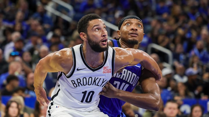 Oct 25, 2024; Orlando, Florida, USA; Brooklyn Nets guard Ben Simmons (10) and Orlando Magic center Wendell Carter Jr. (34) look for the rebound during the second half at Kia Center. Mandatory Credit: Mike Watters-Imagn Images