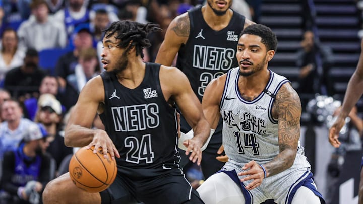 Dec 29, 2024; Orlando, Florida, USA; Brooklyn Nets guard Cam Thomas (24) moves the ball in front of Orlando Magic guard Gary Harris (14) during the second half at Kia Center. Mandatory Credit: Mike Watters-Imagn Images