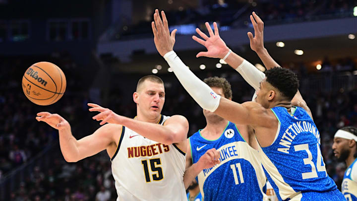  Denver Nuggets center Nikola Jokic (15) passes against Milwaukee Bucks forward Giannis Antetokounmpo (34) in the third quarter at Fiserv Forum. Mandatory Credit: Benny Sieu-Imagn Images