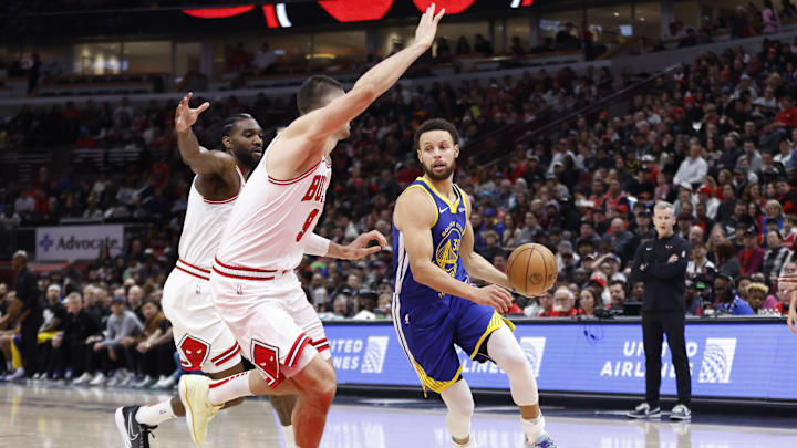 Jan 12, 2024; Chicago, Illinois, USA; Golden State Warriors guard Stephen Curry (30) drives against Chicago Bulls center Nikola Vucevic (9) during the first half at United Center. Mandatory Credit: Kamil Krzaczynski-Imagn Images