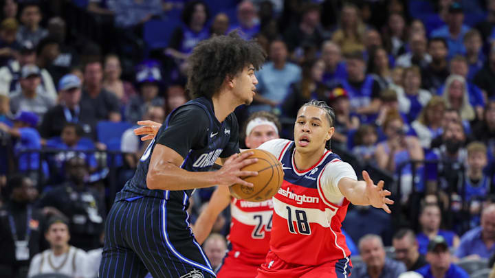 Nov 10, 2024; Orlando, Florida, USA; Washington Wizards forward Kyshawn George (18) defends Orlando Magic guard Anthony Black (0) during the second quarter at Kia Center. Mandatory Credit: Mike Watters-Imagn Images