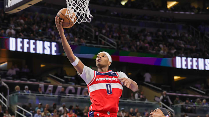 Feb 23, 2025; Orlando, Florida, USA; Washington Wizards guard Bilal Coulibaly (0) shoots the ball in front of Orlando Magic center Wendell Carter Jr. (34) during the second quarter at Kia Center. Mandatory Credit: Mike Watters-Imagn Images