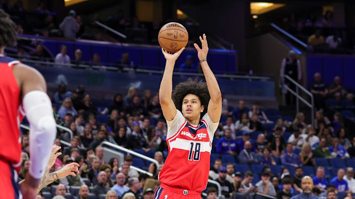 Feb 23, 2025; Orlando, Florida, USA; Washington Wizards forward Kyshawn George (18) shoots a three point basket during the first quarter against the Orlando Magic at Kia Center. Mandatory Credit: Mike Watters-Imagn Images