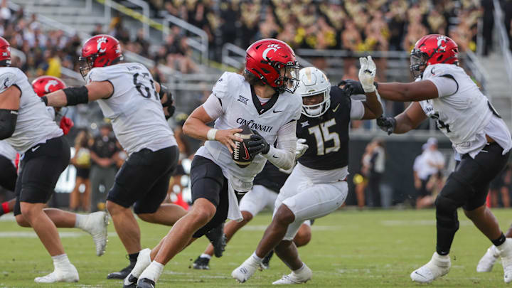 Oct 12, 2024; Orlando, Florida, USA; Cincinnati Bearcats quarterback Brendan Sorsby (2) rolls back to pass during the second half against the UCF Knights at FBC Mortgage Stadium. Mandatory Credit: Mike Watters-Imagn Images Oct 12, 2024; Orlando, Florida, USA; Cincinnati Bearcats quarterback Brendan Sorsby (2) rolls back to pass during the second half against the UCF Knights at FBC Mortgage Stadium. Mandatory Credit: Mike Watters-Imagn Images