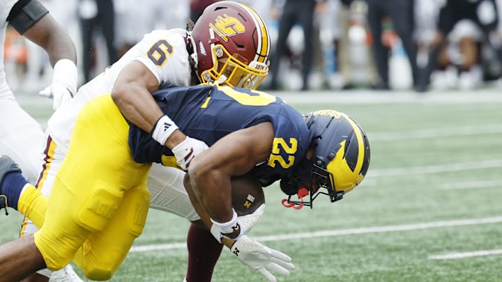 Sep 13, 2025; Ann Arbor, Michigan, USA; Michigan Wolverines running back Justice Haynes (22) drags Central Michigan Chippewas defensive back Kalen Carroll (6) into the end zone for a touchdown in the first half at Michigan Stadium. Mandatory Credit: Rick Osentoski-Imagn Images Sep 13, 2025; Ann Arbor, Michigan, USA; Michigan Wolverines running back Justice Haynes (22) drags Central Michigan Chippewas defensive back Kalen Carroll (6) into the end zone for a touchdown in the first half at Michigan Stadium. Mandatory Credit: Rick Osentoski-Imagn Images