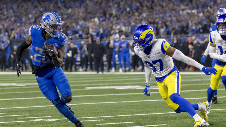Jan 14, 2024; Detroit, Michigan, USA; Detroit Lions running back Jahmyr Gibbs (26) runs for a touchdown against Los Angeles Rams safety Quentin Lake (37) during the first half of a 2024 NFC wild card game at Ford Field. Mandatory Credit: David Reginek-USA TODAY Sports