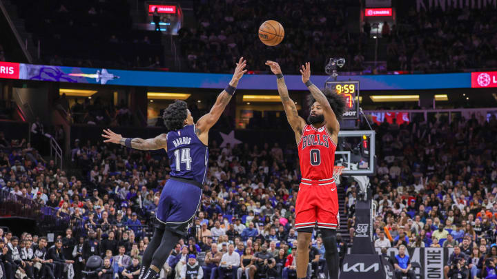 Feb 10, 2024; Orlando, Florida, USA; Chicago Bulls guard Coby White (0) shoots the ball over Orlando