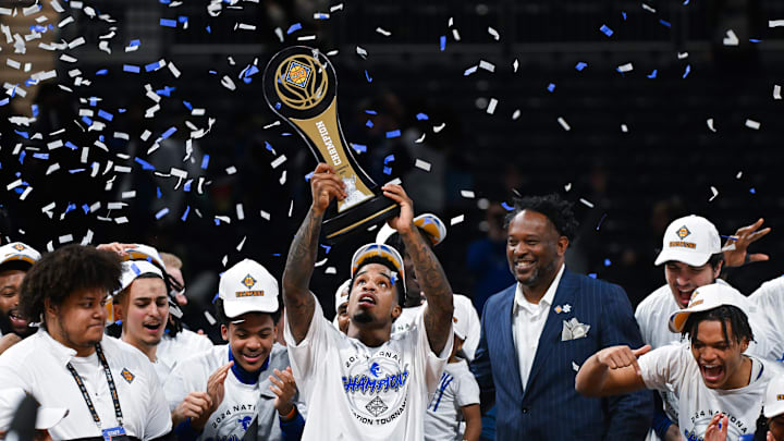 Seton Hall guard Al-Amir Dawes (2) celebrates with the NIT trophy.