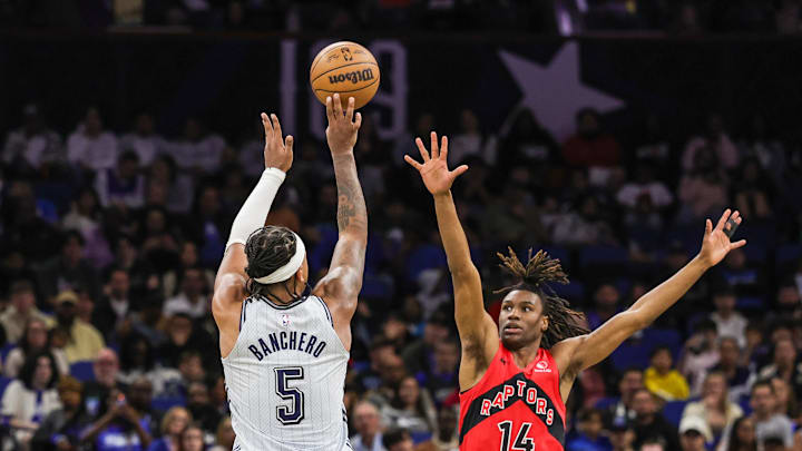 Orlando Magic forward Paolo Banchero (5) shoots over Toronto Raptors guard Ja'Kobe Walter (14) during the second half at Kia Center.