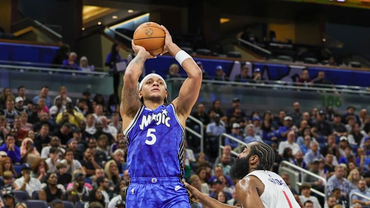 Orlando Magic forward Paolo Banchero shoots the ball against LA Clippers guard James Harden.