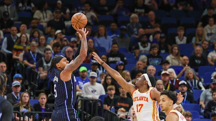Apr 8, 2025; Orlando, Florida, USA; Orlando Magic forward Paolo Banchero (5) shoots against Atlanta Hawks forward Onyeka Okongwu (17) during the first quarter at Kia Center. Mandatory Credit: Mike Watters-Imagn Images