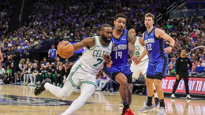 Boston Celtics guard Jaylen Brown drives to the basket against Orlando Magic guard Gary Harris.